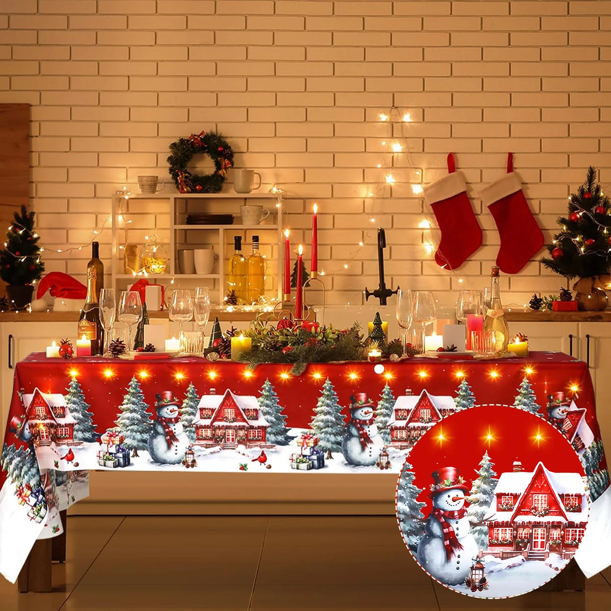 A festive holiday table setting featuring a red tablecloth decorated with Christmas scenes and lights.