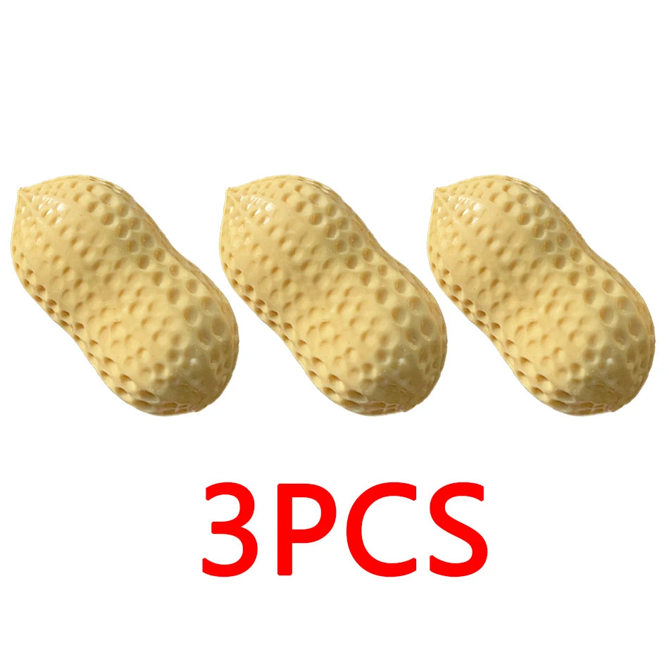 Three light yellow peanut-shaped stress balls or fidget toys.