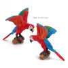 Hand-painted resin parrot figurine with red, blue, and green feathers on a wooden base.