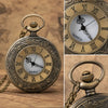 A vintage bronze quartz pocket watch with a chain and ornate engraving, shown in detail.