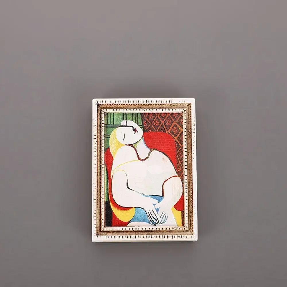 A framed painting featuring a serene figure in yellow and white against a red background, used as a fridge magnet.