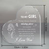 A clear heart-shaped acrylic keepsake engraved with a message to a girl and a rose design.