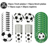 A collection of soccer balls, cups, napkins, and various sized plates are displayed for party decorations.
