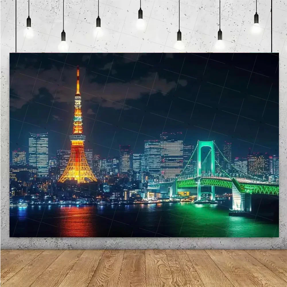 A photograph of the Tokyo skyline at night featuring the Tokyo Tower and a large suspension bridge reflecting on the water.