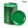 A stack of green 7-inch disposable paper plates.