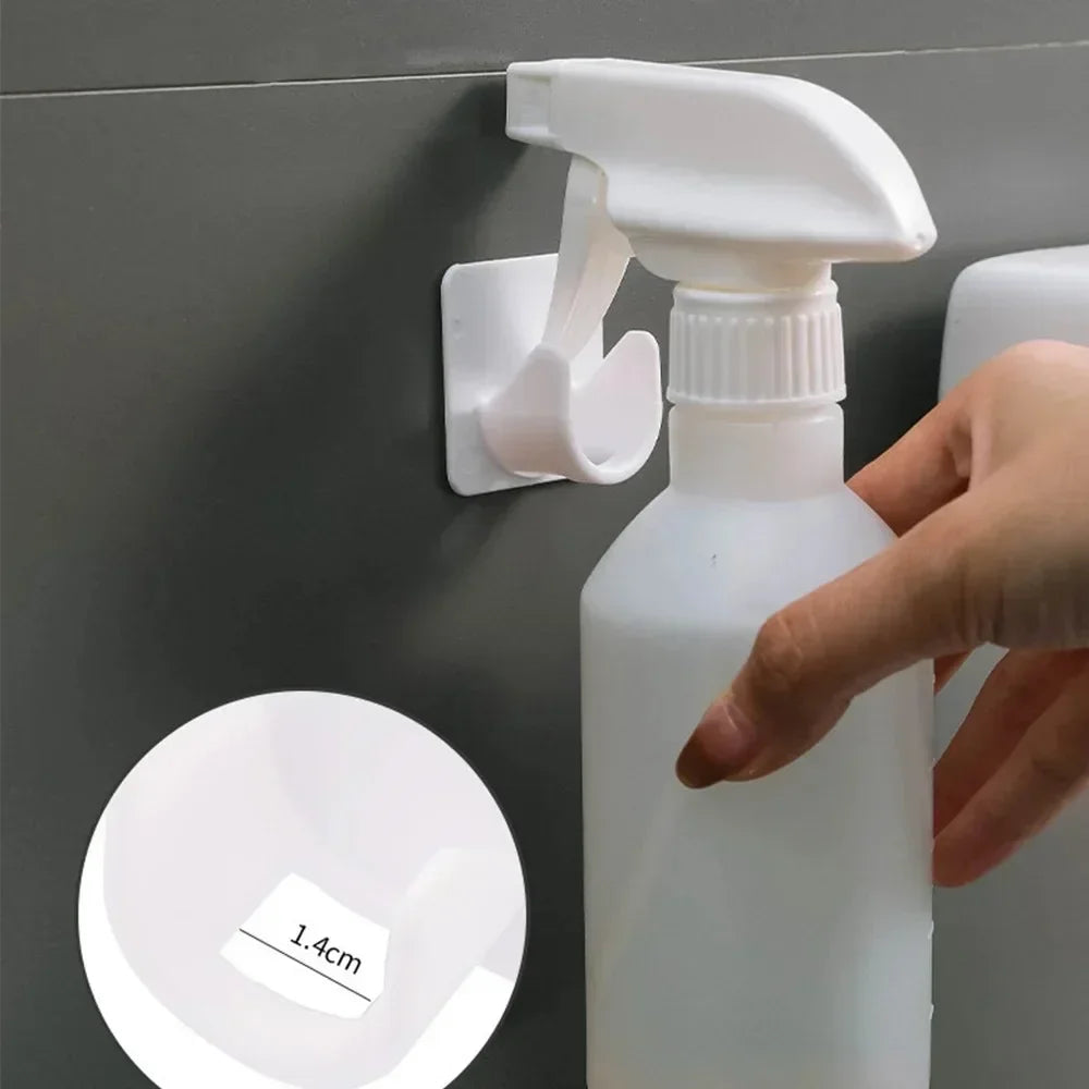 A hand is holding a white plastic bottle with a pump dispenser against a gray wall, next to a circular measurement guide.