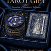 A dark blue box holds a tarot candle featuring crystal stones and an illustration of the High Priestess card.