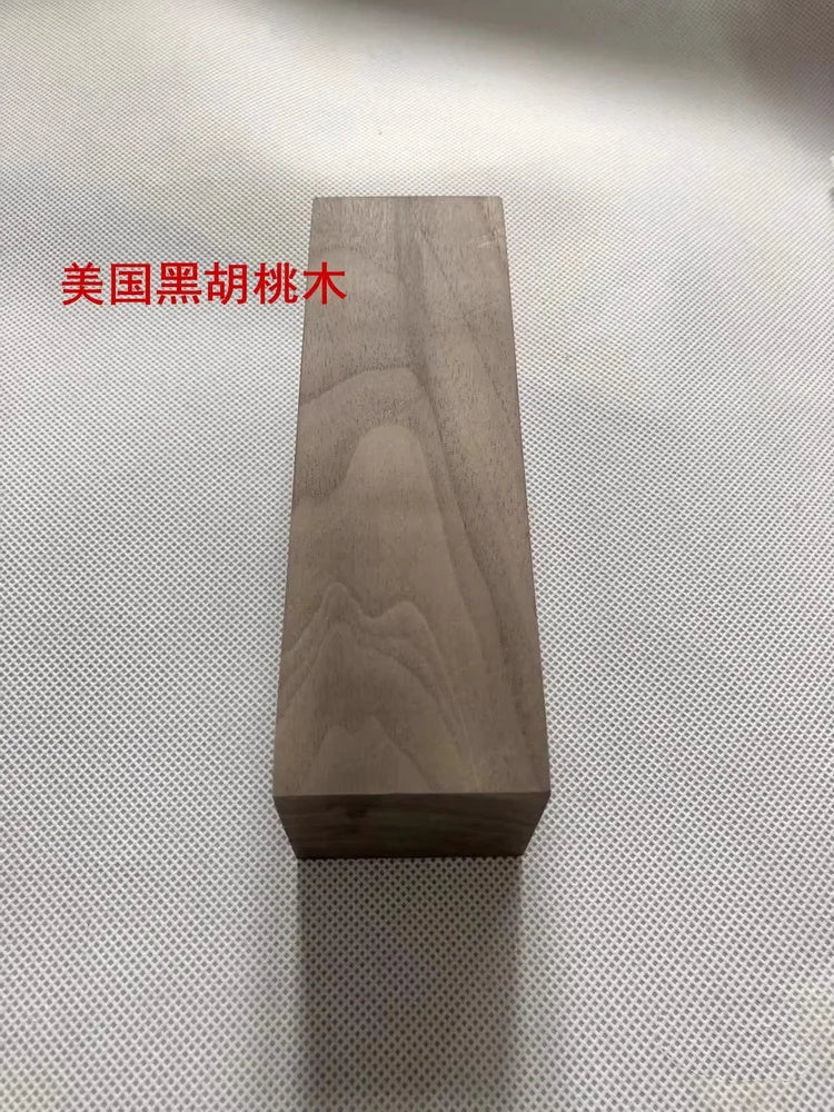 A rectangular block of dark wood, likely a blank for knife handles or DIY projects.