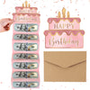 A pink birthday cake design made from US dollar bills and envelopes, with a hand holding the top layer.
