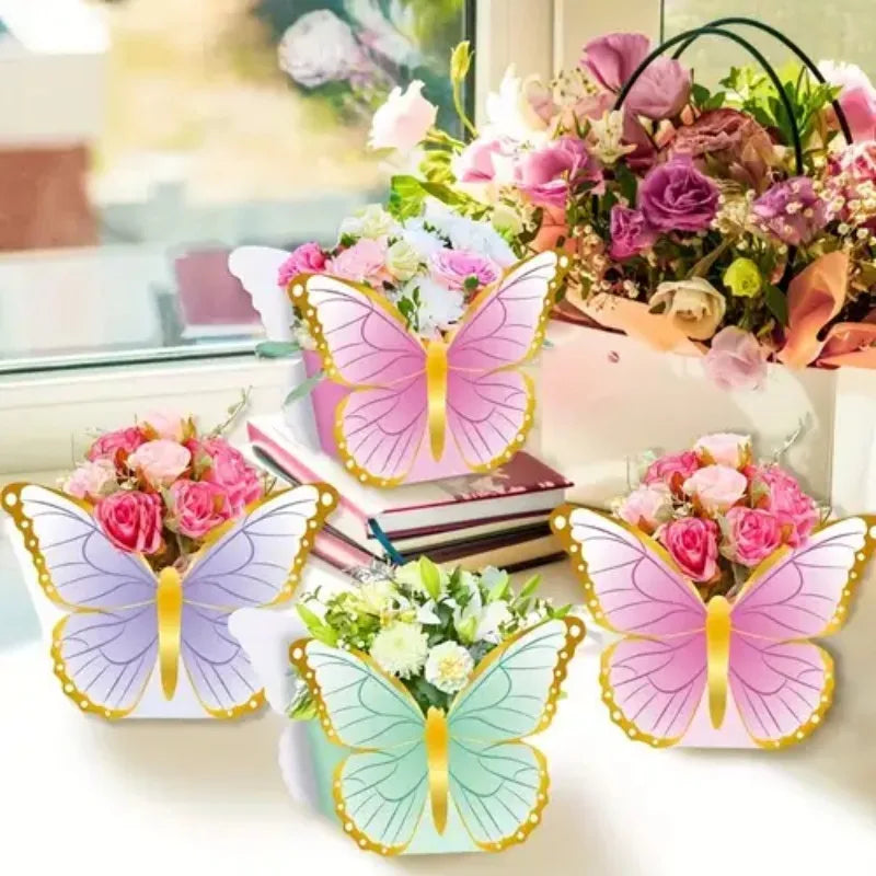A collection of pink and purple butterfly-shaped table decor, including flowers and greenery.