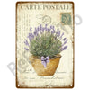 Vintage postcard featuring lavender in a terracotta pot with a purple bow on an aged metal sign.