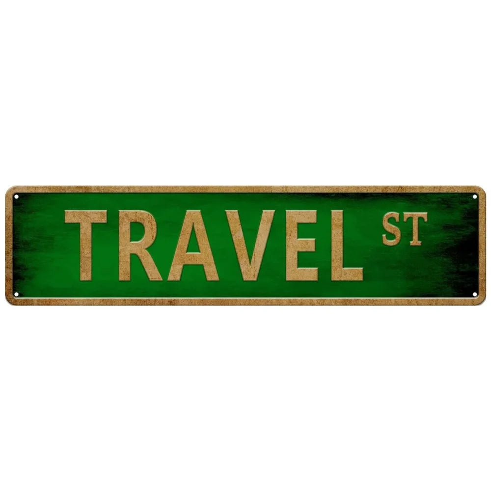 A rectangular green metal tin sign with the text TRAVEL ST in gold lettering.