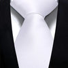 A close-up of a white silk necktie tied in a simple knot against a black suit jacket.