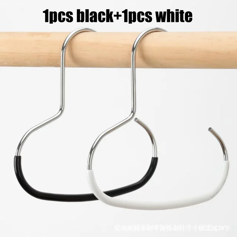 One black and one white round manganese steel hook hanging from a wooden rod.