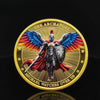 A gold medal coin featuring a winged warrior figure of the Archangel Michael with a shield and sword.