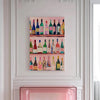 A vertical print featuring a colorful arrangement of vintage wine bottles on a pink background.
