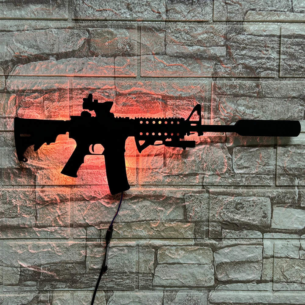 A black gun-shaped LED light mounted on a stone wall, illuminated with an orange glow.