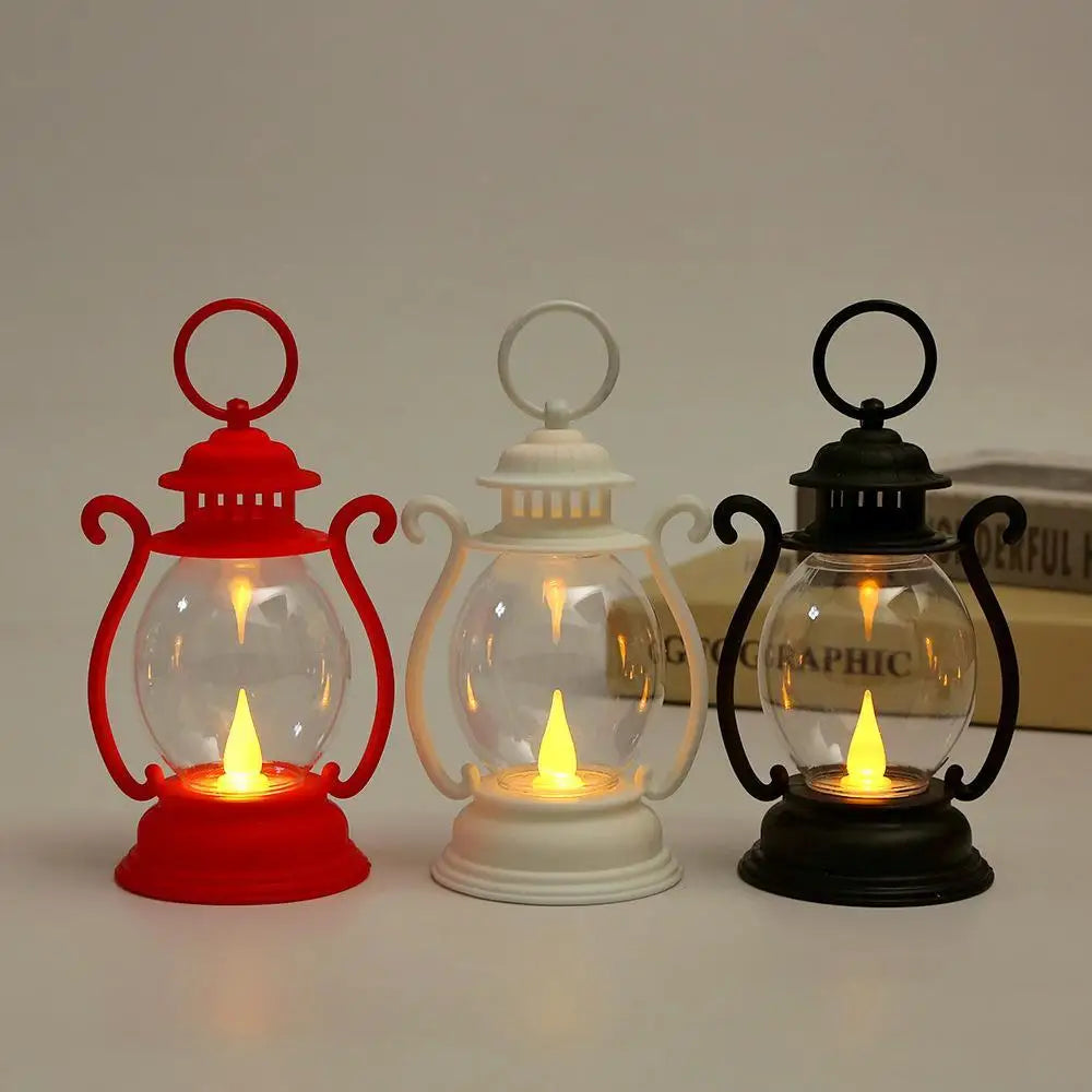 Three retro battery-powered desk lamps in red, white, and black glass with illuminated bulbs.