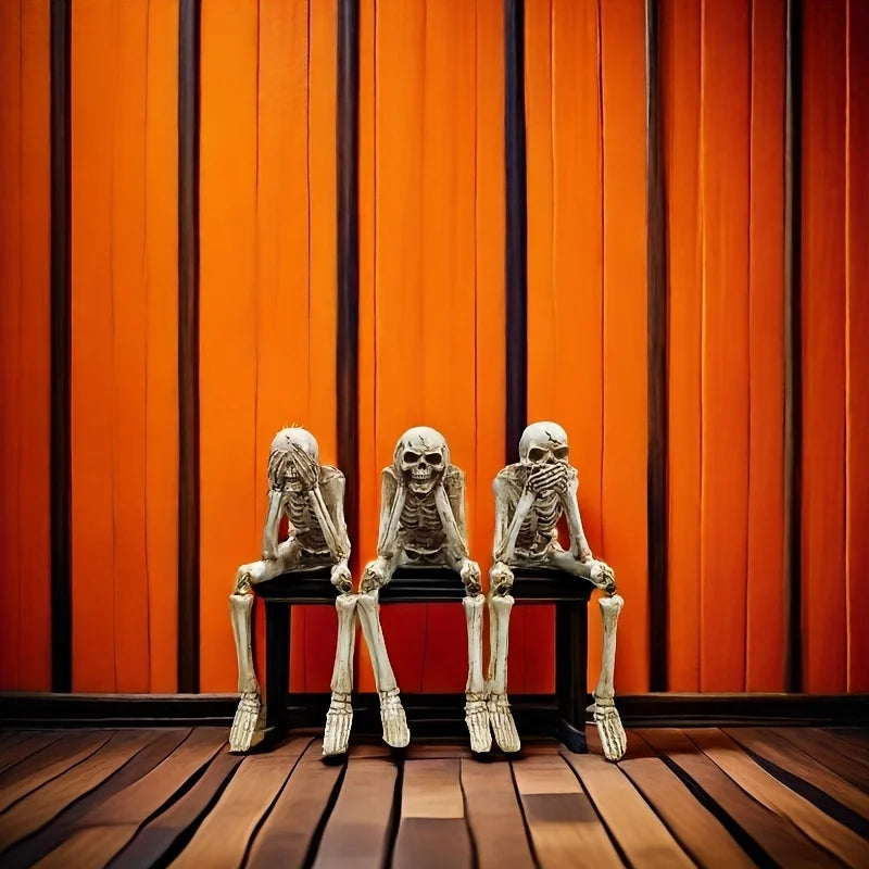 A set of realistic Halloween skeleton resin statues displayed against an orange vertical wood panel background.
