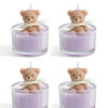 Four soy wax teddy bear candles in glass jars with white ribbon
