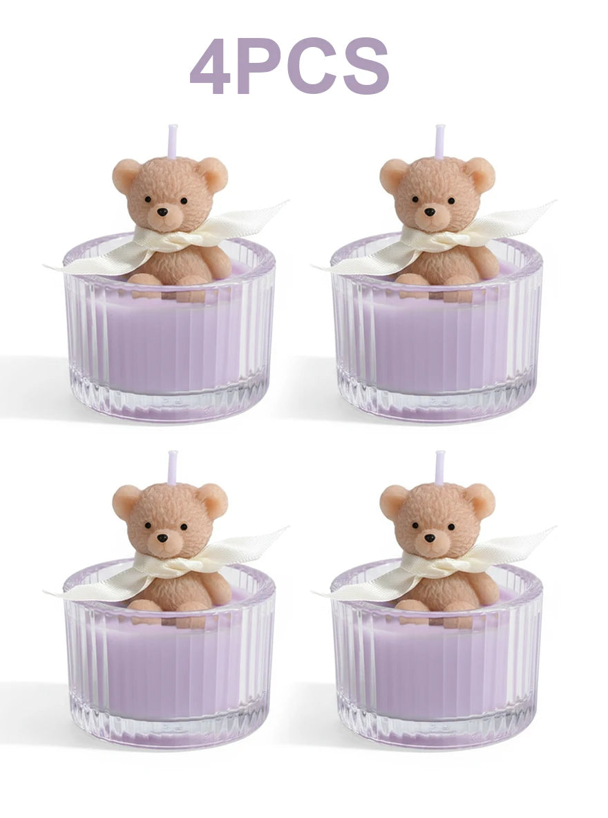 Four soy wax teddy bear candles in glass jars with white ribbon