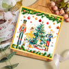 Christmas nutcracker watercolor paper napkins displayed on a wooden board with festive greenery and ornaments