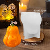 A white silicone mold shaped like a pumpkin is displayed next to an orange Halloween pumpkin.