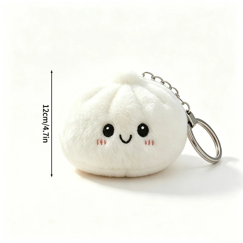 A white plush butter dumpling squishy keychain with a smiling face and silver keyring.