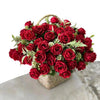 A vibrant bouquet of deep red artificial roses arranged in a woven basket for wedding and decoration.