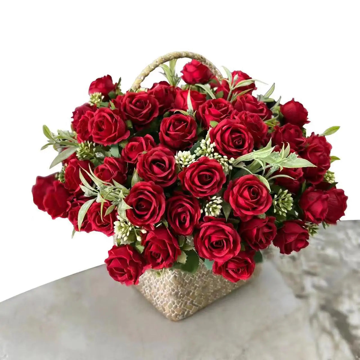A vibrant bouquet of deep red artificial roses arranged in a woven basket for wedding and decoration.