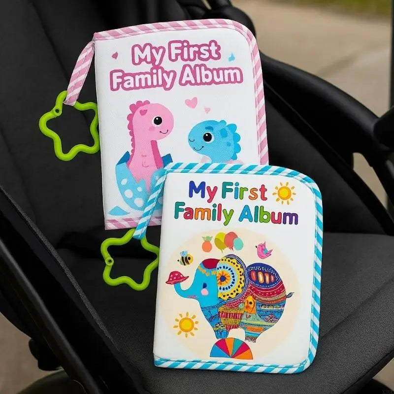 A pink and blue cloth baby photo album with a dinosaur and elephant design resting on a black seat.
