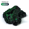 A dark green articulated cat figurine resembling a hairless Sphynx cat, shown in a close-up view.