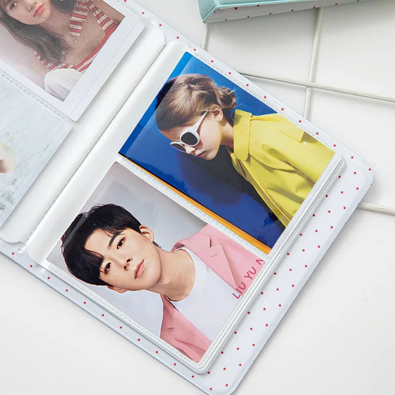 A white photo album with a clear cover displaying two photos: a woman and a man.