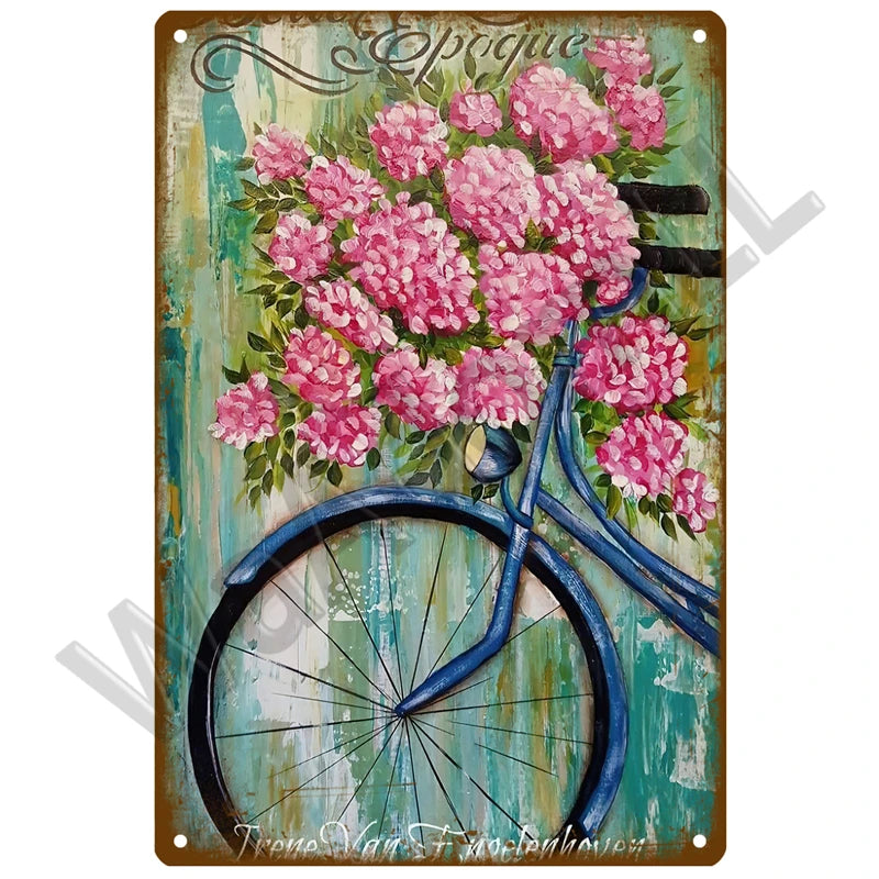 A vintage metal sign featuring a pink peony bouquet and a blue bicycle against a weathered teal background.