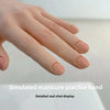 A hand with neatly shaped nails is displayed for simulated manicure practice training.