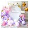 A white photo backdrop decorated with pink and purple balloons, gold stars, and large number balloons.