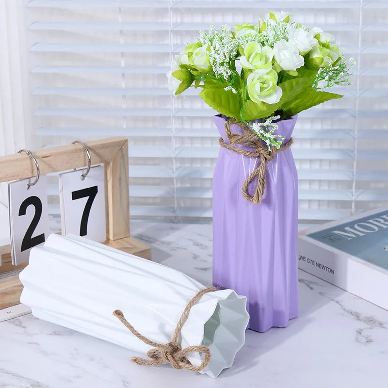 A purple plastic vase holds a bouquet of white and green flowers on a white marble surface.