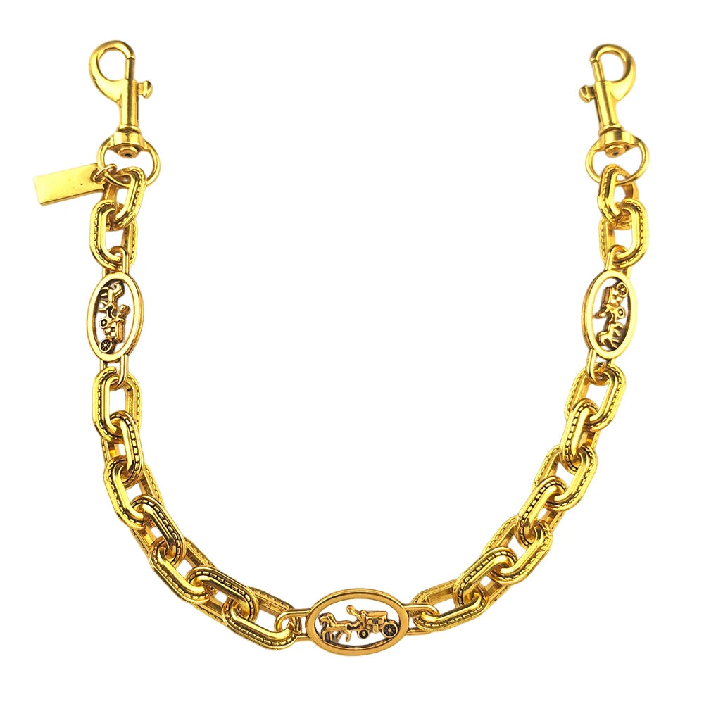 A gold-colored paperclip chain bag strap featuring decorative links and a clasp.