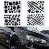 A close-up of a black car featuring realistic 3D bullet hole vinyl decals on the body panel.
