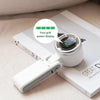 A white foldable mini handheld fan is shown resting on a white box with a power display indicator.