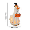 A white ghost figurine with a black hat and orange beak, illuminated for Halloween decor.