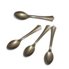 A set of gold polka dot disposable party tableware including a spoon and a fork.