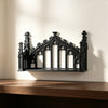 A black ornate Gothic wall shelf featuring intricate carvings and arched openings mounted on a light-colored wall.