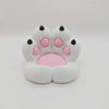 A white silicone cat paw phone stand with pink accents and a stress relief design.