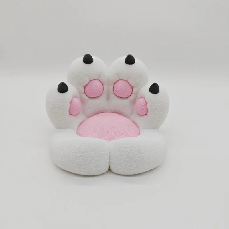 A white silicone cat paw phone stand with pink accents and a stress relief design.