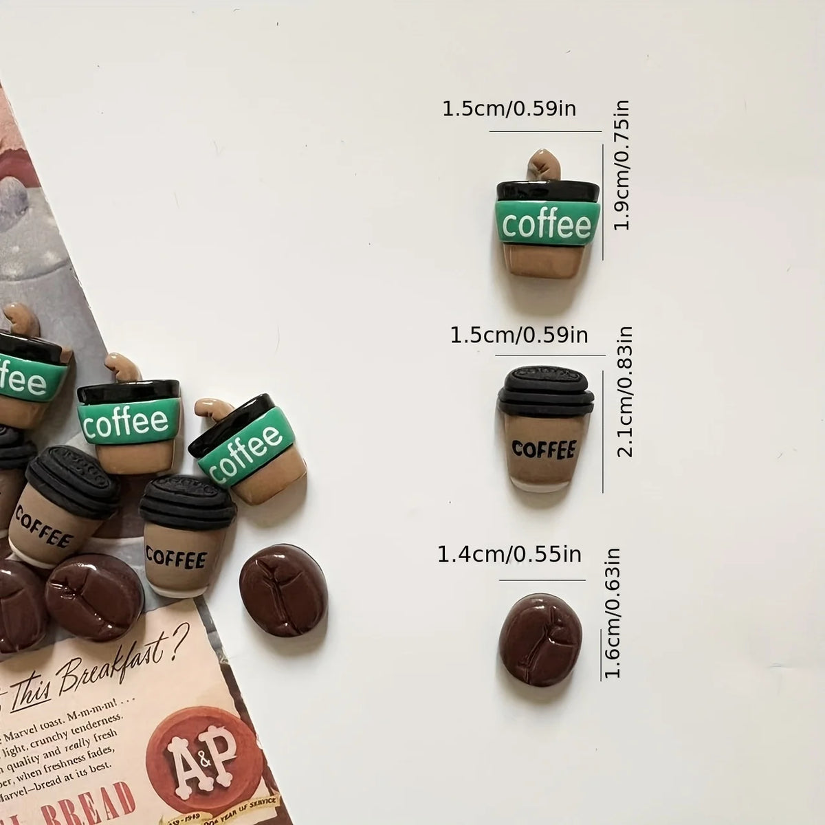A collection of coffee bean fridge magnets in various shades and sizes displayed on a white surface.