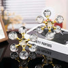 Gold molecular sculpture desk decor featuring clear glass spheres on a white box.