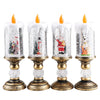 Four glass candles with snowflake designs and gold bases