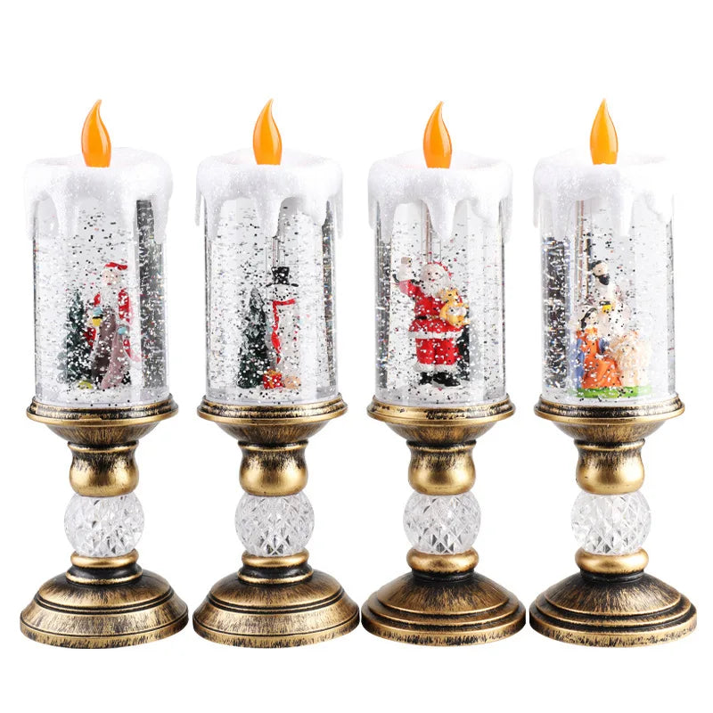 Four glass candles with snowflake designs and gold bases