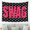 A black tapestry with large pink polka dots featuring the word SWAG in bold letters.